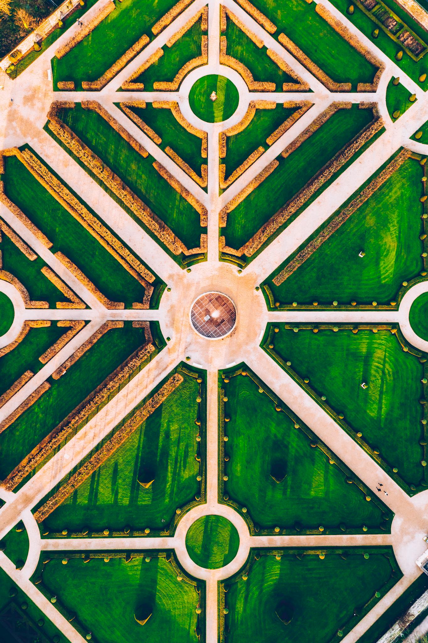 Stunning aerial view capturing the intricate symmetry and vibrant green designs of a formal garden.